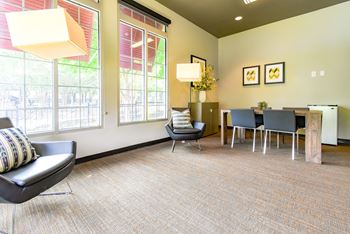 a living room with a table and chairs and a large window at Riverset Apartments, Memphis, TN, 38103